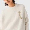 Sweater with floral brooch Sweater with floral brooch